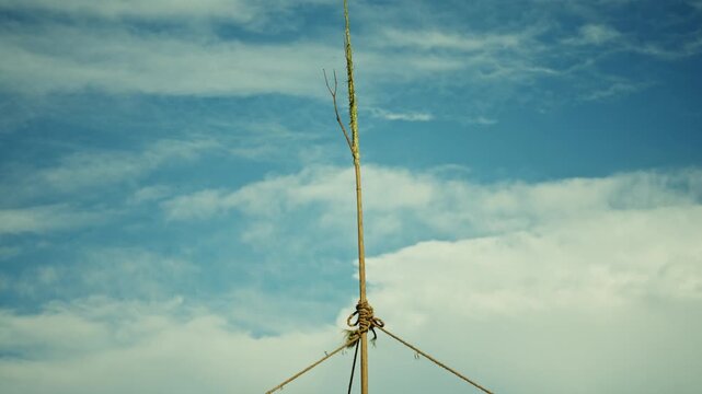 Rope knot ties bamboo poles atop festival swing frame in Nepal