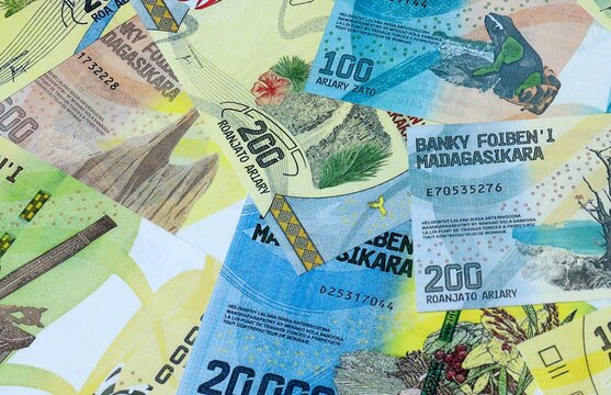 Malagasy ariary money bills in pile on table. Madagascar MGA currency cash close up