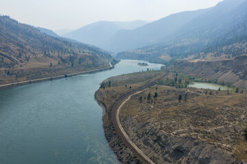 Naklejka premium Aerial View of Thompson River Valley and Railway Bend Near Spences Bridge, British Columbia, Canada
