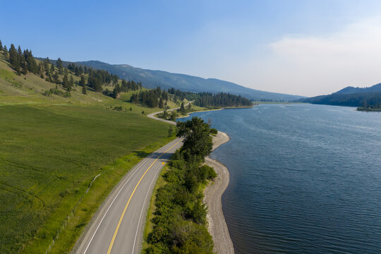 Scenic Winding Road Along Mamit Lake Shoreline With Mountains and Forest in British Columbia, Canada