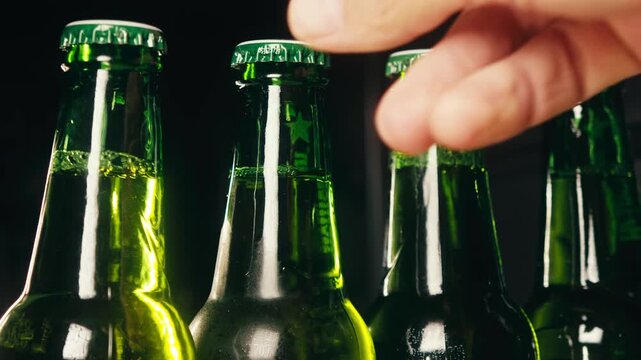 Row of beer bottles in fridge, shop or hotel, cold lager craft german beer or cider, shop supermarket or wine cooler close up.