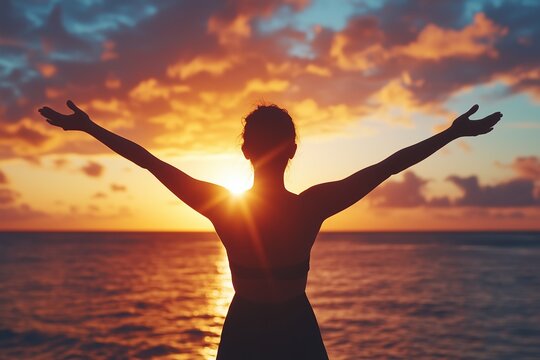 Silhouette of Woman Celebrating at Sunset by the Ocean