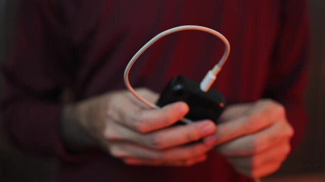 Close Up of Charging Cable Connected to Electronic Device with Selective Focus