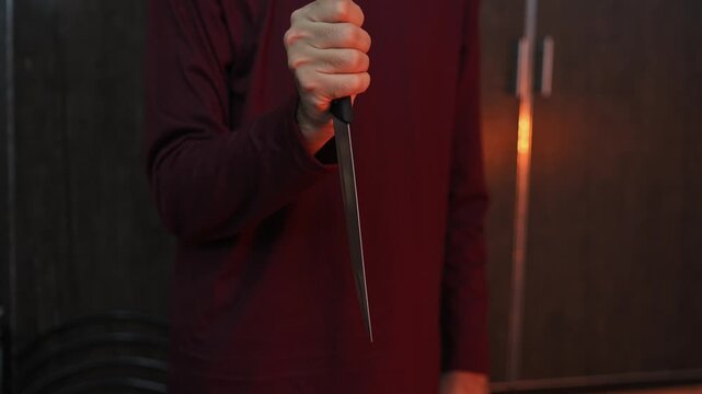 Close Up of Hands Holding Kitchen Knife Showing Sharp Blade