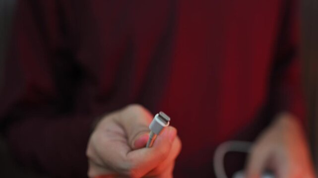 Close-up of type C wire for charging phone. Action. Type-C connector for charging phone on isolated ofn. New wire type C and included for phone