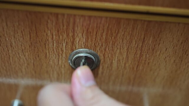Macro Shot of Key Inserted in Wooden Drawer Lock