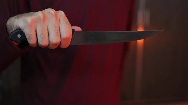 Macro Shot of Sharp Chef Knife Held in Human Hand
