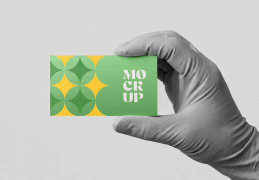 Gloved Hand Holding Colorful Business Card Mockup with Geometric Pattern
