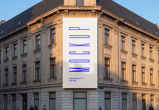 Vertical Billboard Mockup on Historic Building Facade at Sunset
