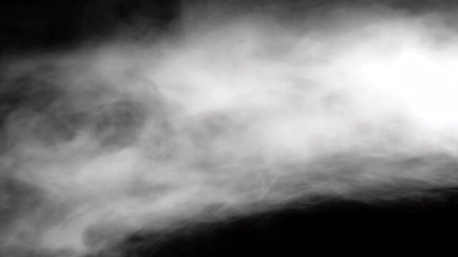 Abstract ethereal smoke and mist flowing on dark background.