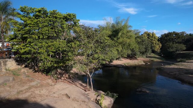 Static view of Rio das Almas rocky banks and green vegetation in Brazil