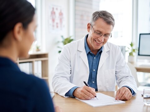 Smiling Doctor Writing Medical Prescription in Bright Modern Clinic with High Key Lighting and Soft Blurred Background