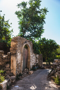 a narrow street in the small Greek town of Margarites on the island of Crete