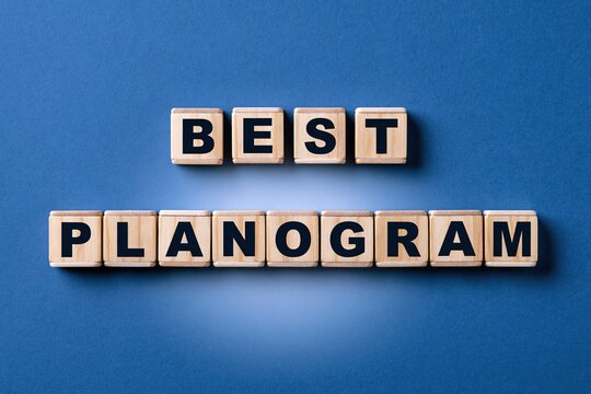 Best planogram words created with wooden alphabet tiles over a solid blue background