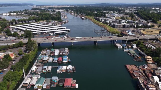 Aerial of urban waterway and marina confluence in Portland Oregon on Columbia River with multiple docks and boat storage