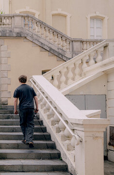 Young Man Walking Up Stairway