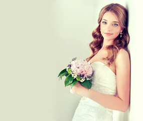 Fashion blonde bride girl  in gorgeous wedding dress with wedding bouquet of flowers © Sofia Zhuravetc