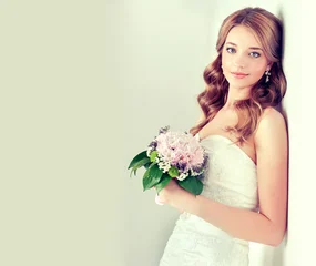 Fashion blonde bride girl  in gorgeous wedding dress with wedding bouquet of flowers © Sofia Zhuravetc