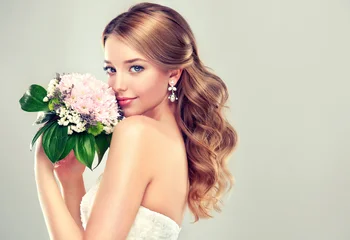 Fashion blonde bride girl  in gorgeous wedding dress with wedding bouquet of flowers © Sofia Zhuravetc