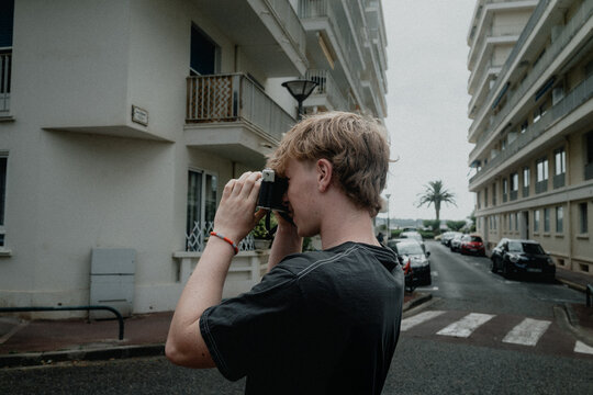 Teen Taking Photo on Vintage Film Camera in Europe