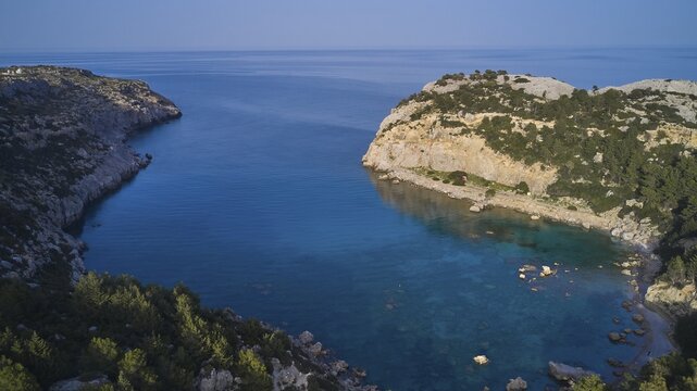 Drone shot, A picturesque, calm bay with crystal clear water and steep cliffs, surrounded by nature, Anthony Quinn Bay, Vagies Bay, Rhodes, Dodecanese, Greek Islands, Greece
