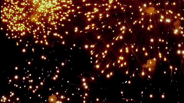 Brilliant fireworks light up the night sky during festive celebrations. Watch as gold, white, and green explosions create a magical atmosphere for Christmas and New Year's Eve.