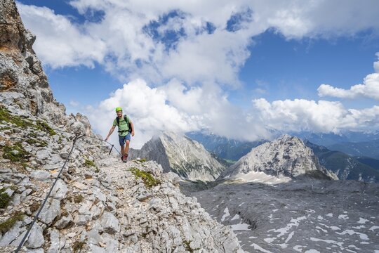 Hikers on the Hermann von Barth trail, via ferrata to the Partenkirchner Dreitorspitze, view of the Leutascher Platt with peak &Ouml;felekopf, Wetterstein range, Bavaria, Germany