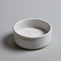 Fototapeta premium Minimalist stoneware dish with sea salt on dove-gray surface