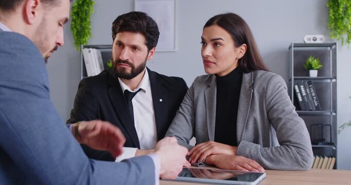 Family couple as client meets with real estate agent or financial consultant in office, discussing insurance during meeting in a professional scene with focus on planning and support.