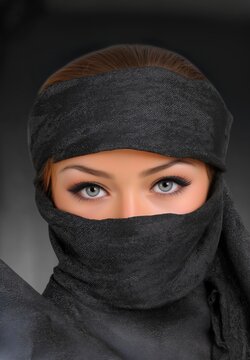 A woman in a black burka and detailed head covering stands in a studio, her striking eye color highlighted by soft natural light