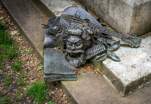 Detail of theatrical mask, sheet music from The Yeoman of the Guard and a mandolin at the base of the Arthur Sullivan Memorial (1903) by William Goscombe John, Victoria Embankment Gardens, London, UK.