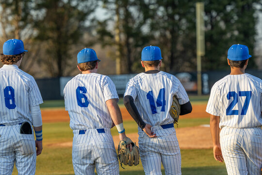Baseball Players standing on first base line during pregame and before the national anthem