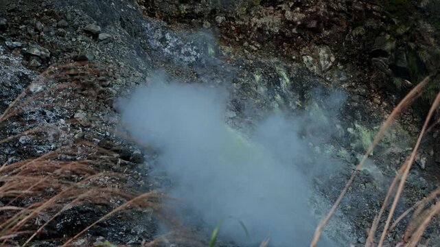 Volcanic geothermal sulfur steam rising from fumarole