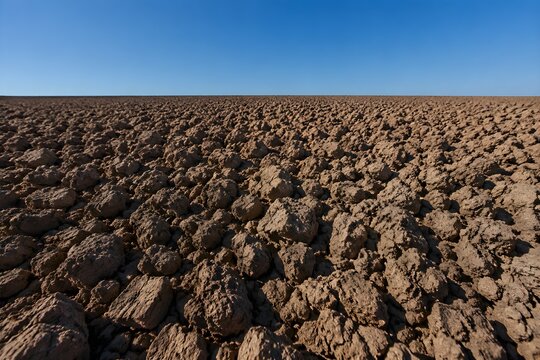 Ploughed field completely devoid of moisture dirt clods baked into hard rock lumps