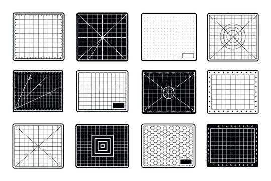 Black and white cutting mats with various grid patterns and measurement lines for crafting and drafting projects