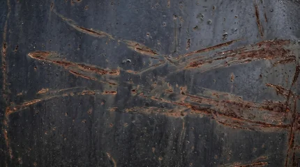 Dark oxidized steel panel with organic rust scuff marks © Said