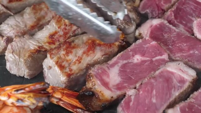 Extreme close-up of tender, marbled beef steak slices being grilled. The footage captures the sizzling process with steam rising, showing a perfect medium-rare pink center and a seared exterior as met