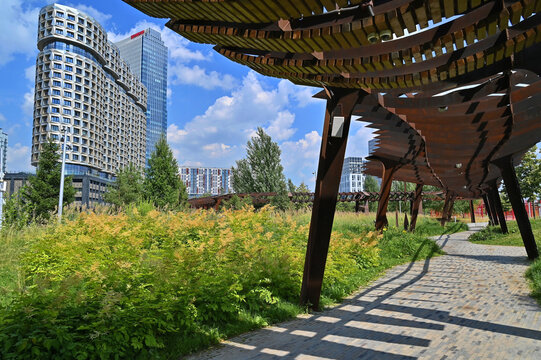 Tyufeleva Roshcha city park in Moscow. Corten steel pergola. Zilart residential complex in the background.