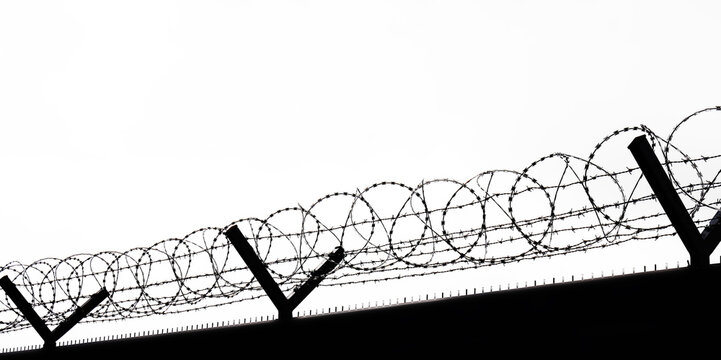  metal grid fence with barbed wire against sky Border of runway Barbed wire drawn in circles isolated on white background