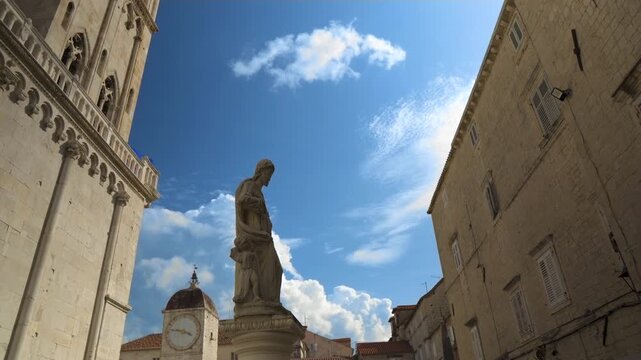 Historic Square with Stone Statue and Medieval Architecture in Trogir, Croatia.