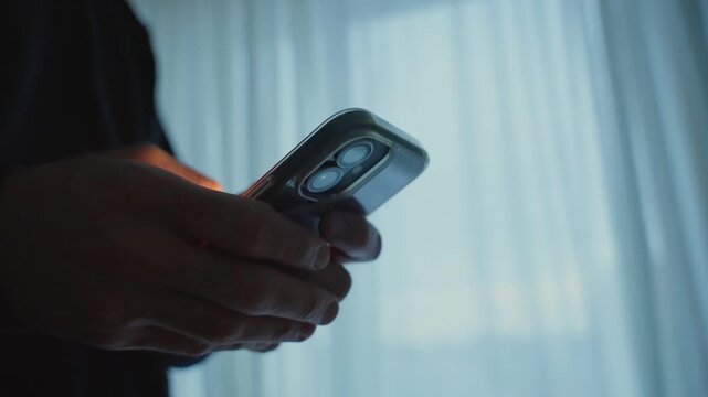 Close up of a person using a smartphone at night
