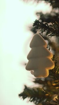 White christmas tree ornament hanging on a branch