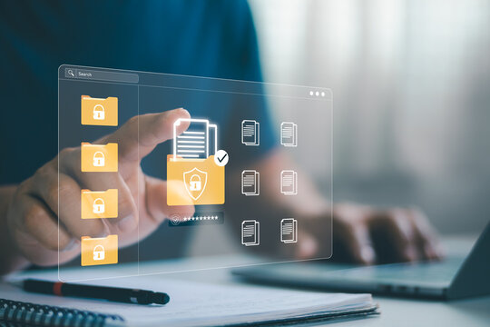 Businessman using laptop computer. Concept of data security with digital documents and security icons in a modern office environment, highlighting the importance of privacy and information protection.