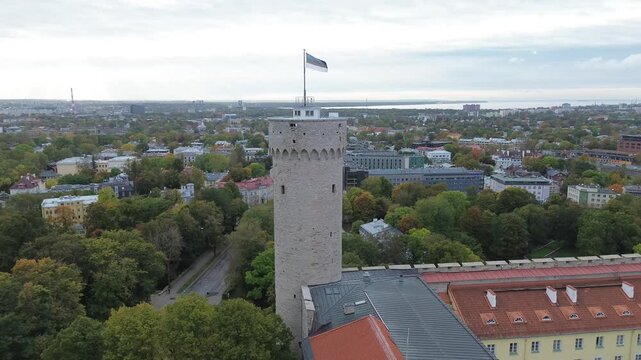 View of Tallinn's Old Town with towers, rooftops, and flag from a tower in Estonia during daytime.Tall Hermann is the defensive tower standing at the southwestern corner of Toompea Castle in Tallinn.