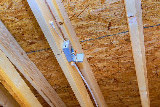 Construction work junction box wiring in ceiling structure of building renovation