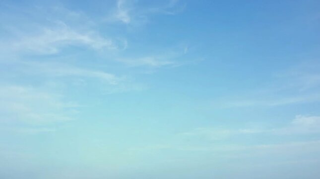 Light blue sky with soft cloud, clear atmosphere, calm weather, airy background, blue cloudscape, and horizonless open space serene scene