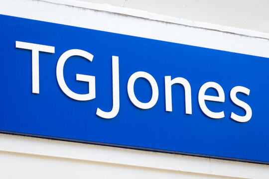 TG Jones store logo, WH Smith formally. Street sign outside British newsagent chain retailer known for stationary, books and convenience store.