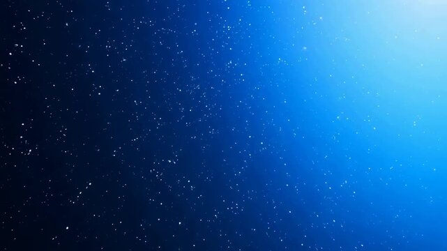 A gradient blue background with scattered white particles resembling stars, creating a cosmic or deep space effect.
