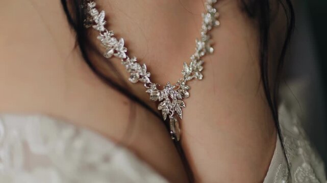 A large jeweled necklace is hanging on the girl's chest. Close-up shooting