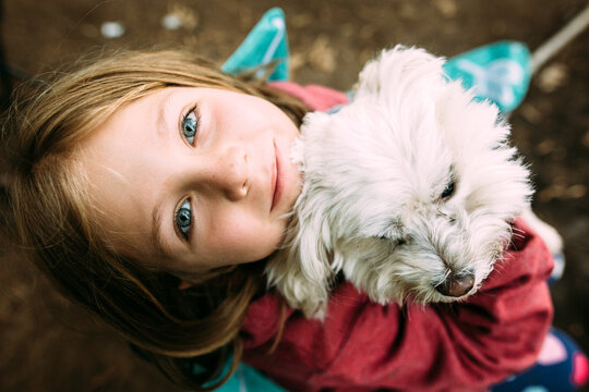 Girl with little dog in camping chair